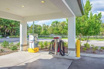 A gas station with several pumps at a gas